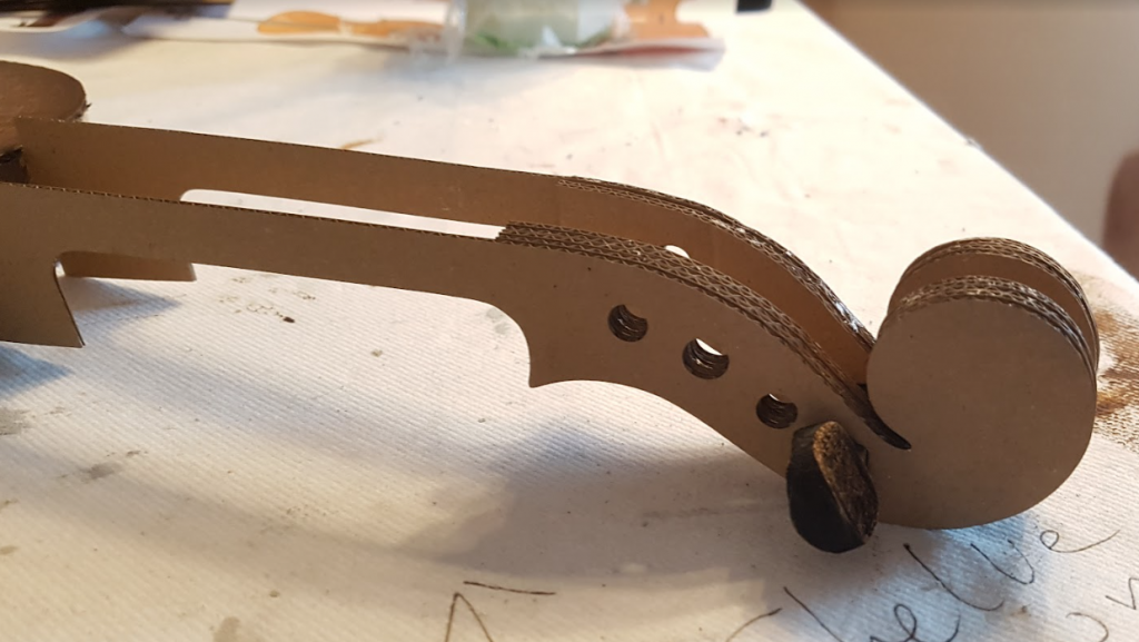 Scroll end with tuning peg